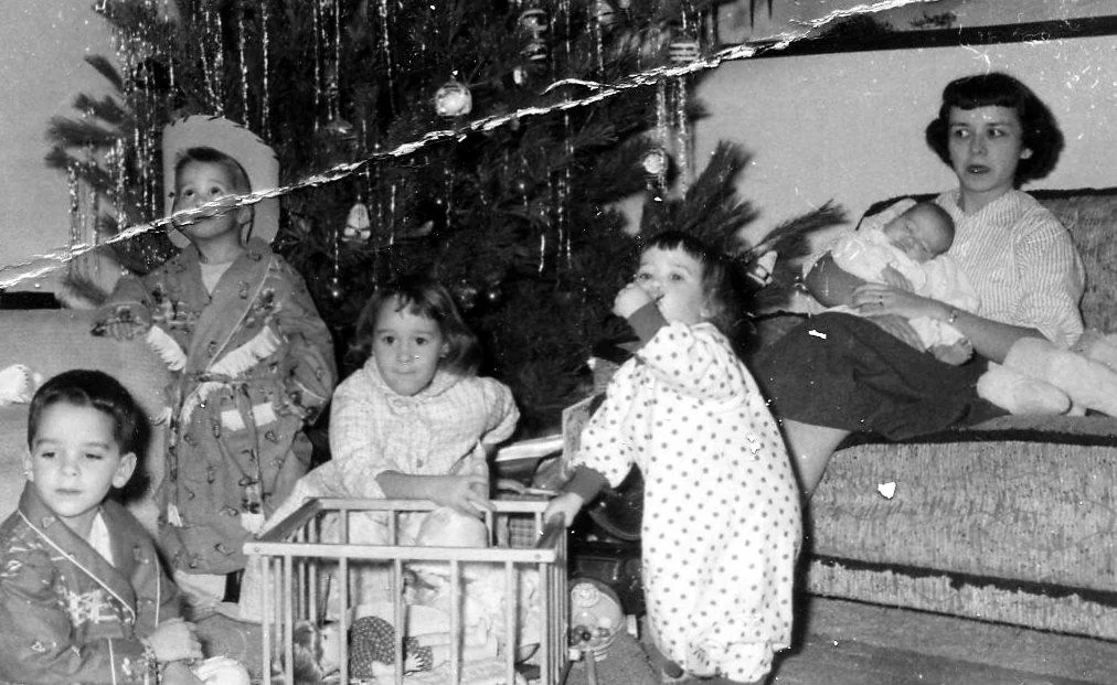 Deeply scratched old portrait with surface damage across faces