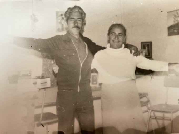 Antique photo with significant physical damage including tears and heavy stains